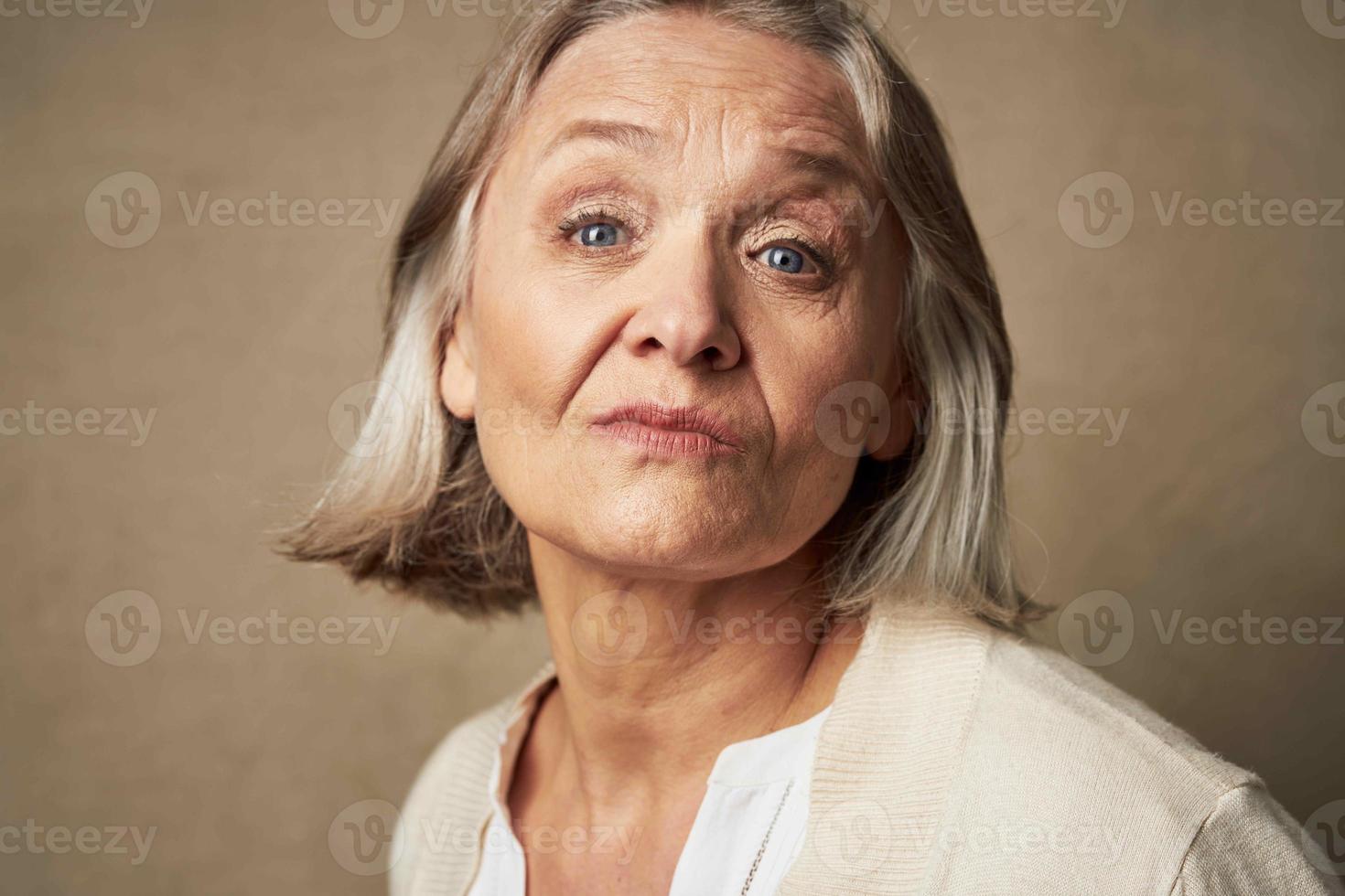 elderly woman in robe face closeup posing isolated background photo