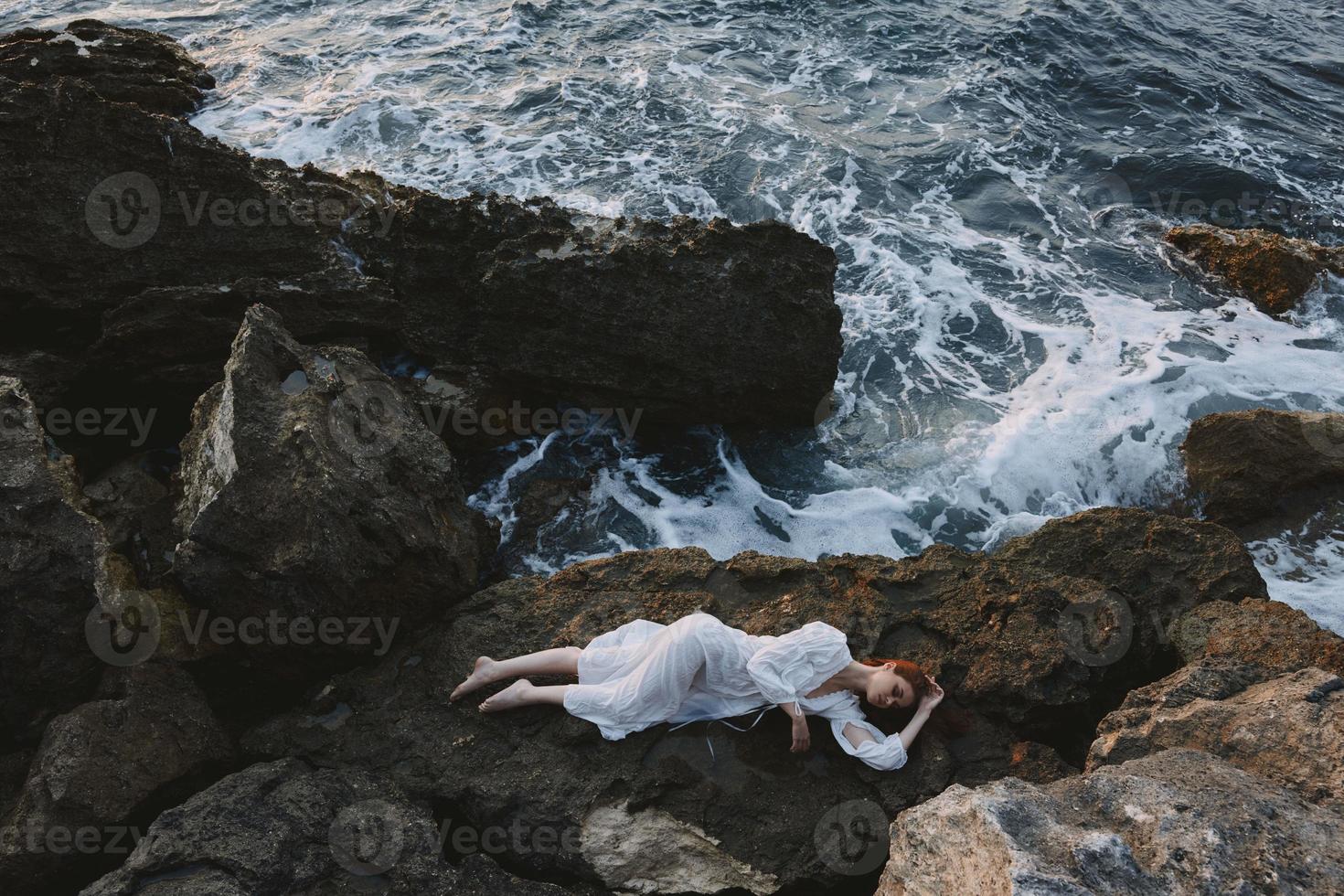 woman in white wedding dress on sea shore wet hair vacation concept photo