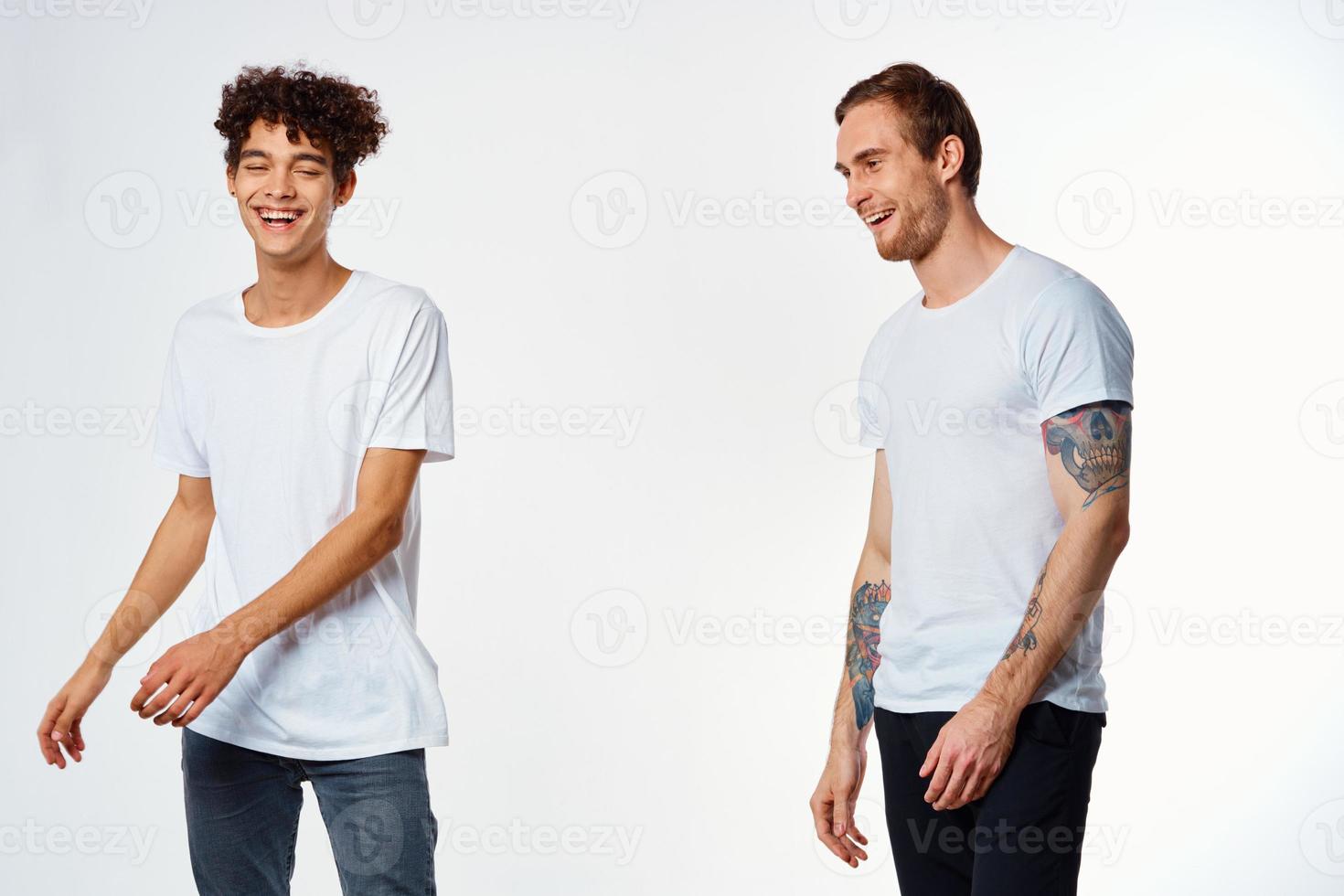 Two cheerful friends in white T-shirts joy Positive light background photo