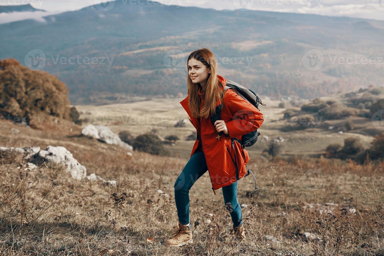 woman with backpack travel mountains landscape jacket boots jeans photo