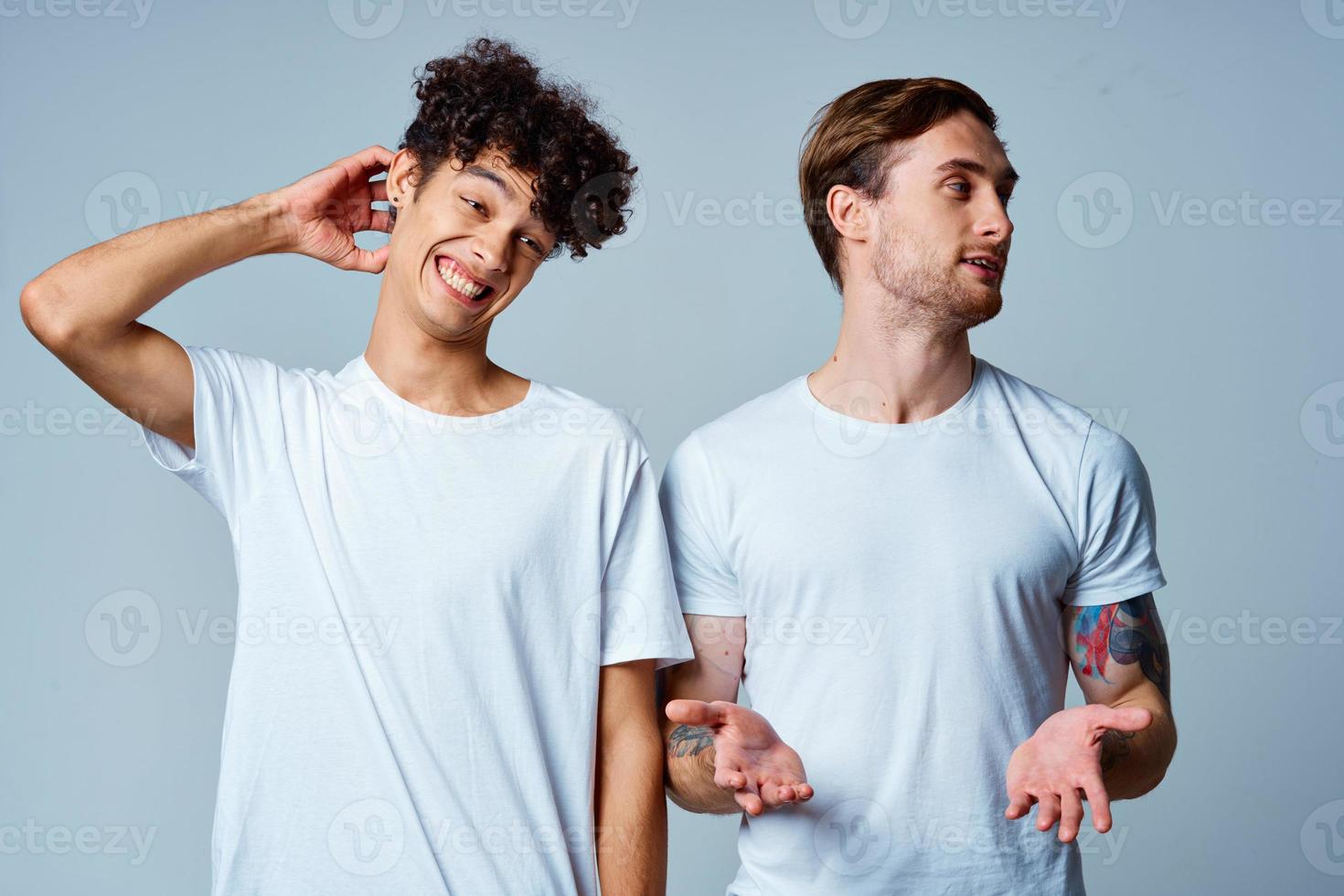 emotional two friends in white t-shirts yes fun studio photo