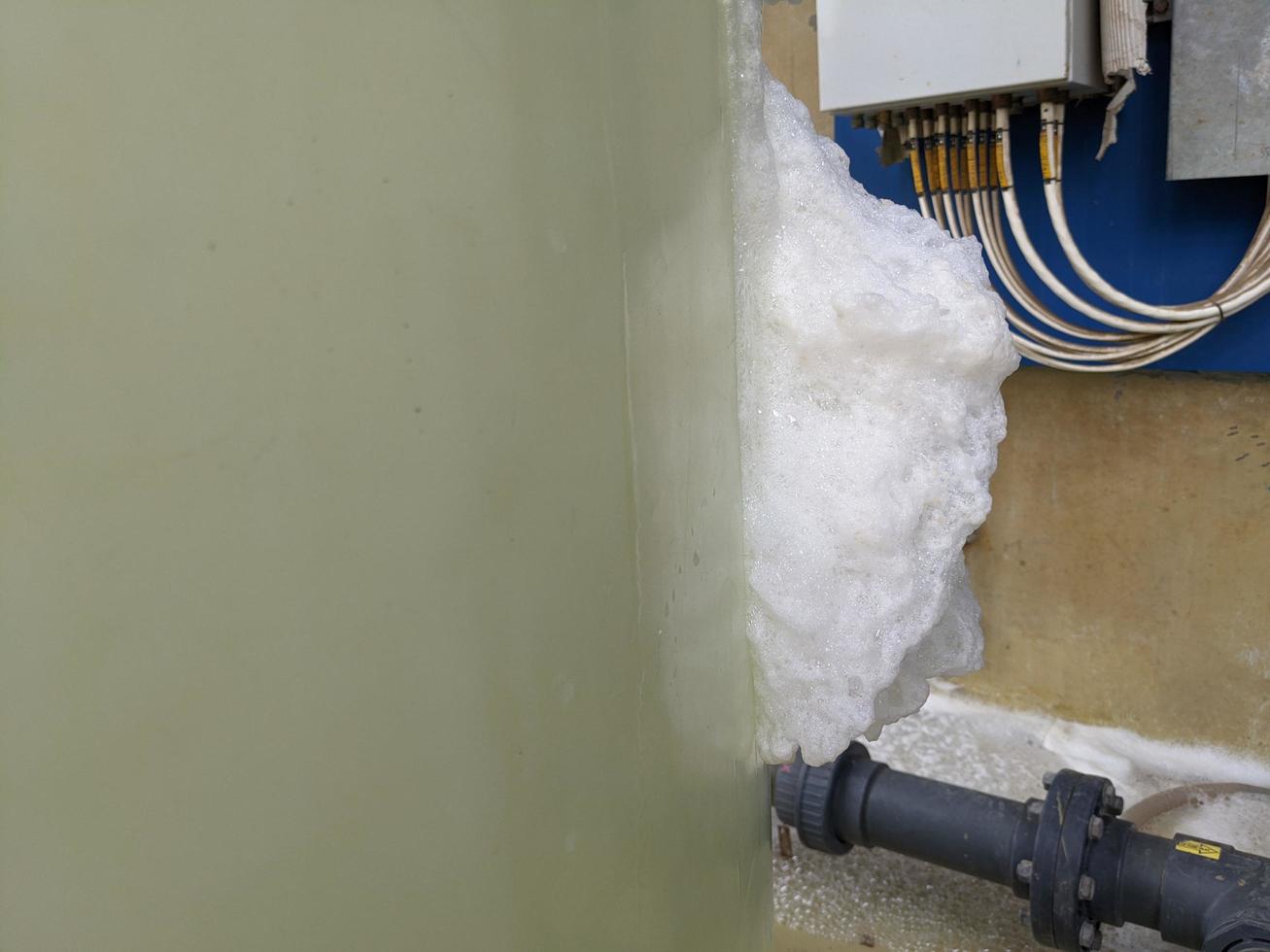 Foaming chemical cleaning water treatment plant reaction of fresh water and impurities. The photo is suitable to use for water treatment plant poster, process cleaning background and content media.
