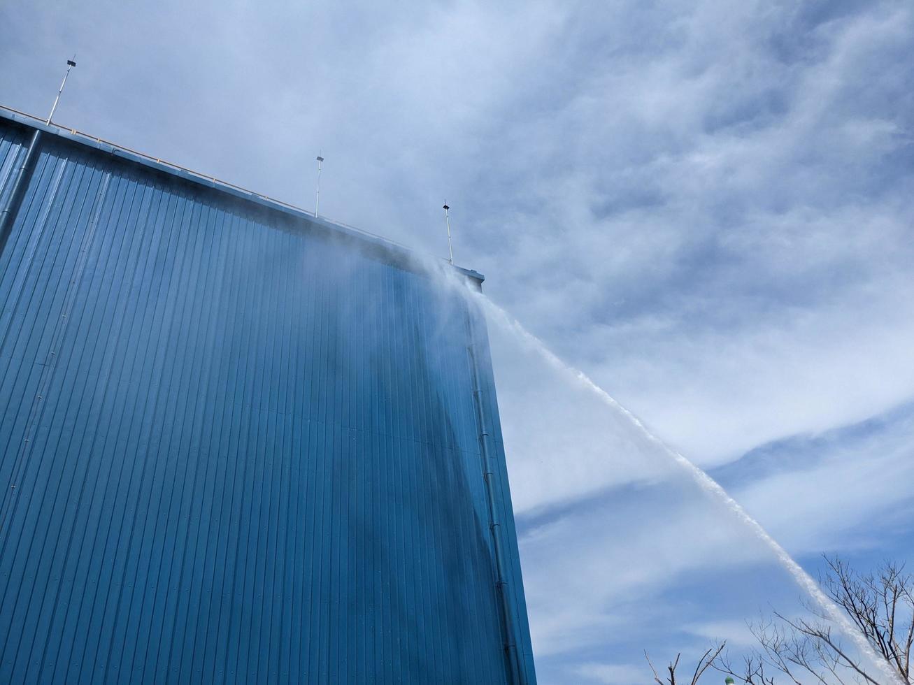 Spray water test hydrant tower on the combine cycle power plant. The photo is suitable to use for industry background photography, power plant poster and electricity content media.