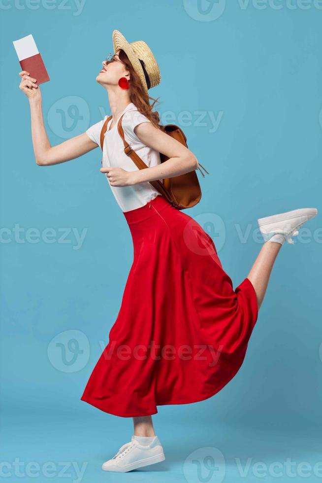 woman in hat with passport and plane tickets travel fun dream blue background photo