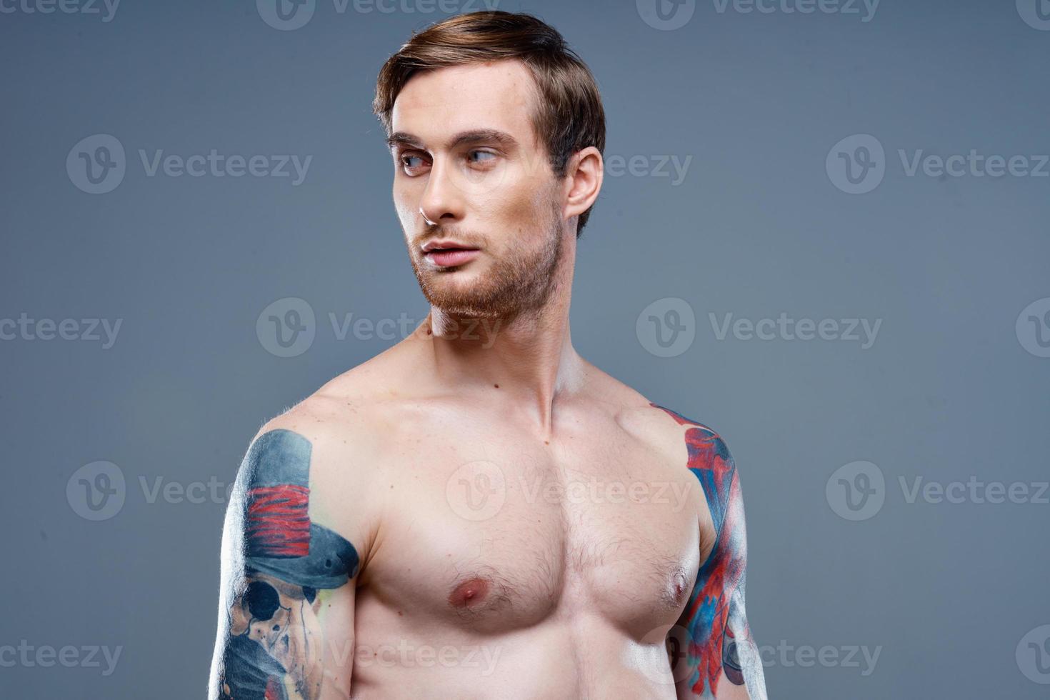 man with tattoo naked torso sport fitness gray background portrait photo