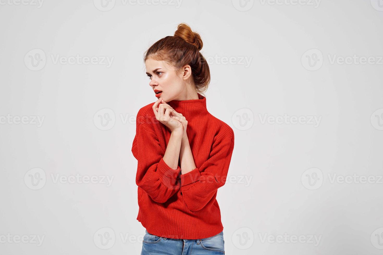 pretty woman in a red sweater light background photo