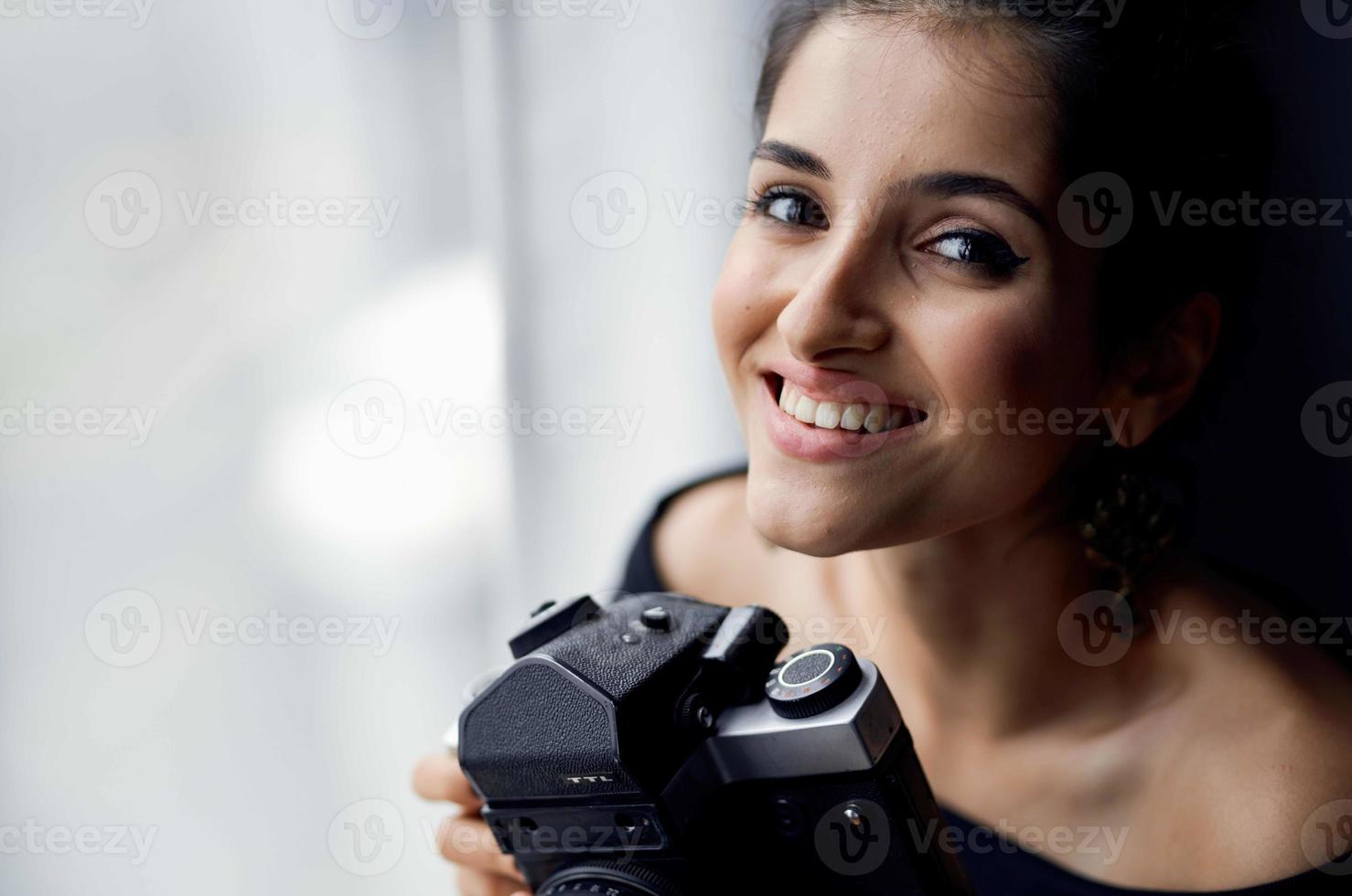 beautiful woman holding a camera near the window decoration fashion fashion model photo