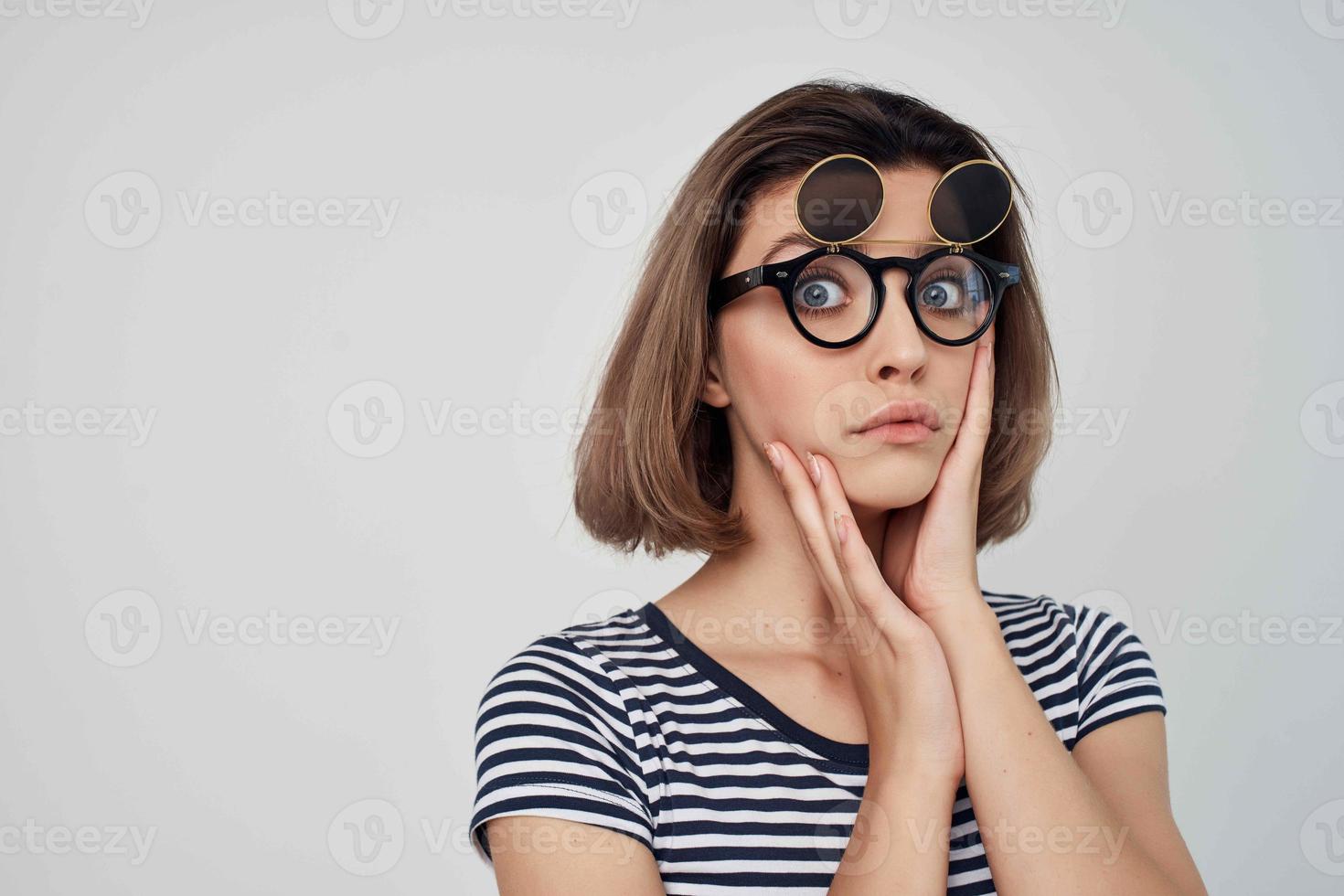 woman in striped t-shirt fashion glasses studio posing photo