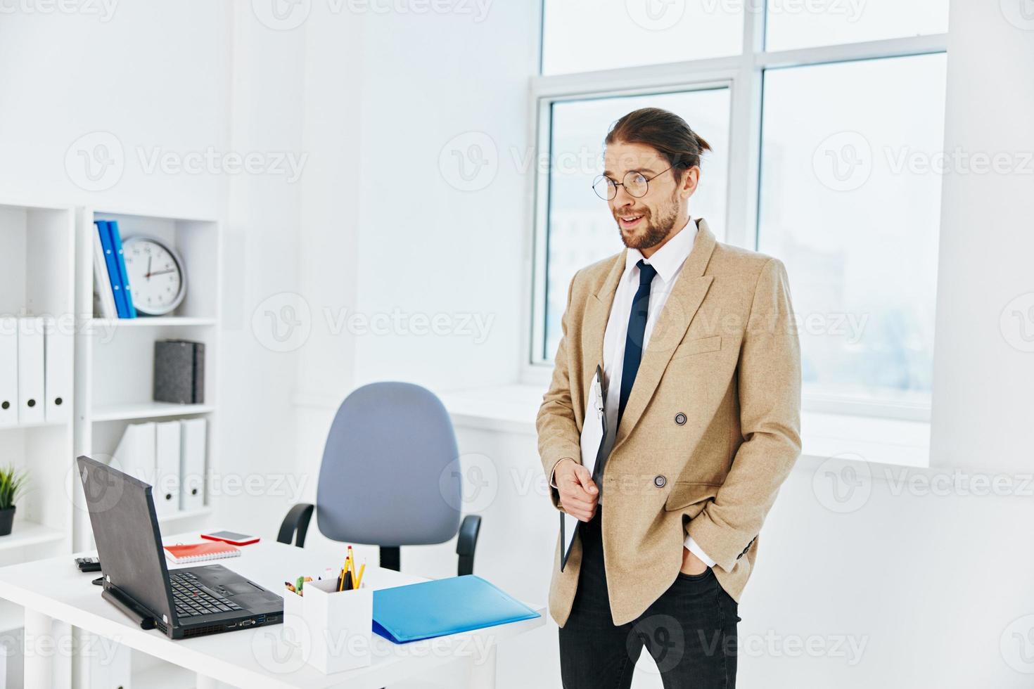 man in beige jacket holding a phone telephone office executive photo