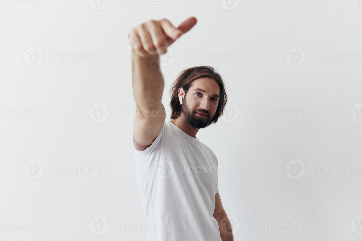 happy man listening to music and smiling in a white t-shirt on a white background happy photo