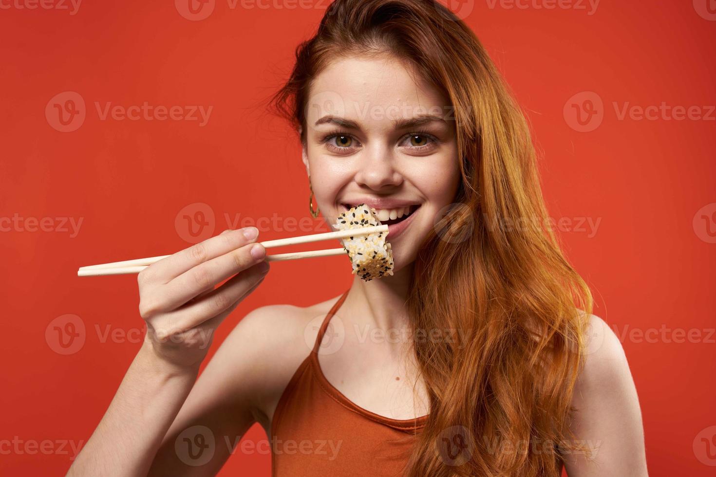 woman in red t shirt chopsticks sushi asian food photo