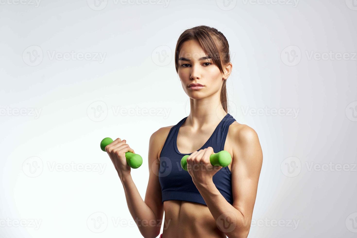 sports woman holding green dumbbells fitness motivation photo