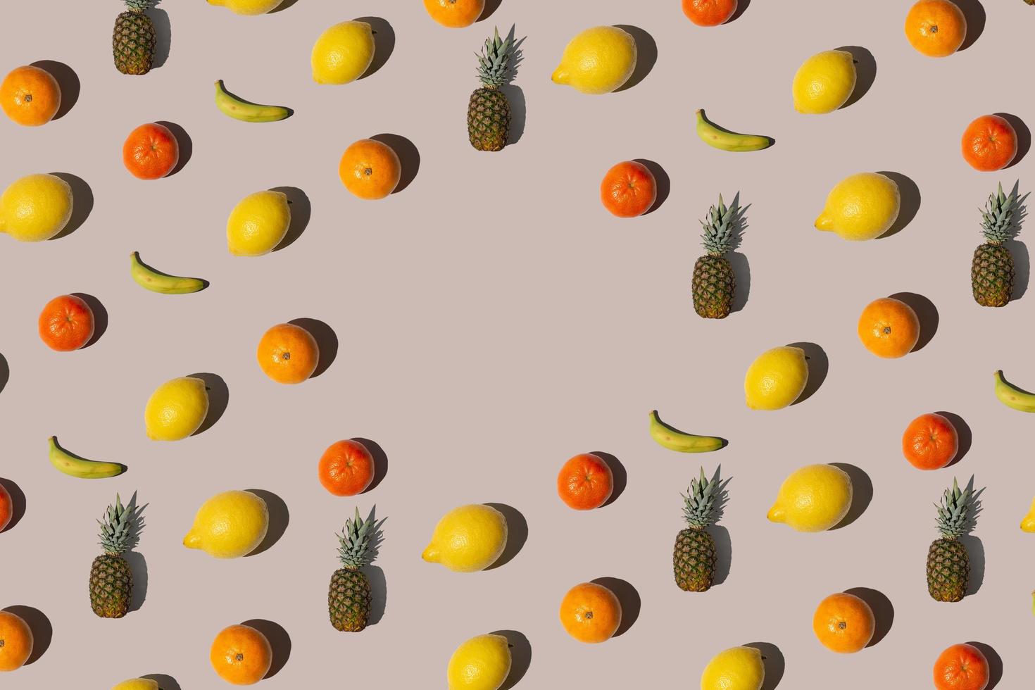 Creative isometric pattern made with tropical fruits on beige Background. Minimal summer fruit layout with copy space. photo