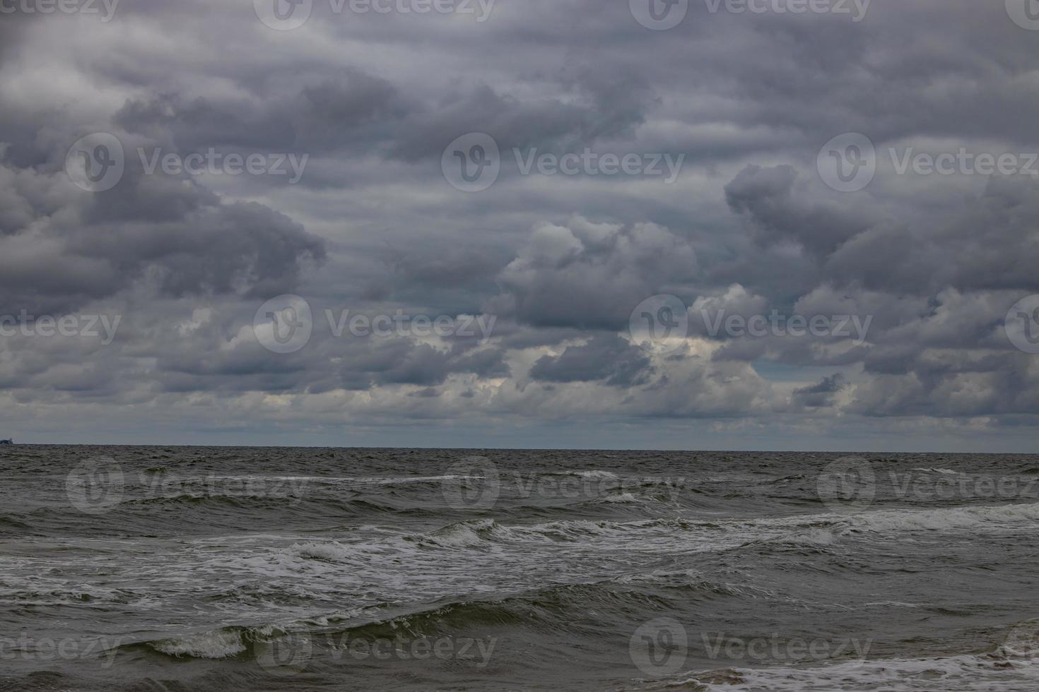 wide beach on the Baltic Sea in Poland on a summer cloudy gray cold day photo