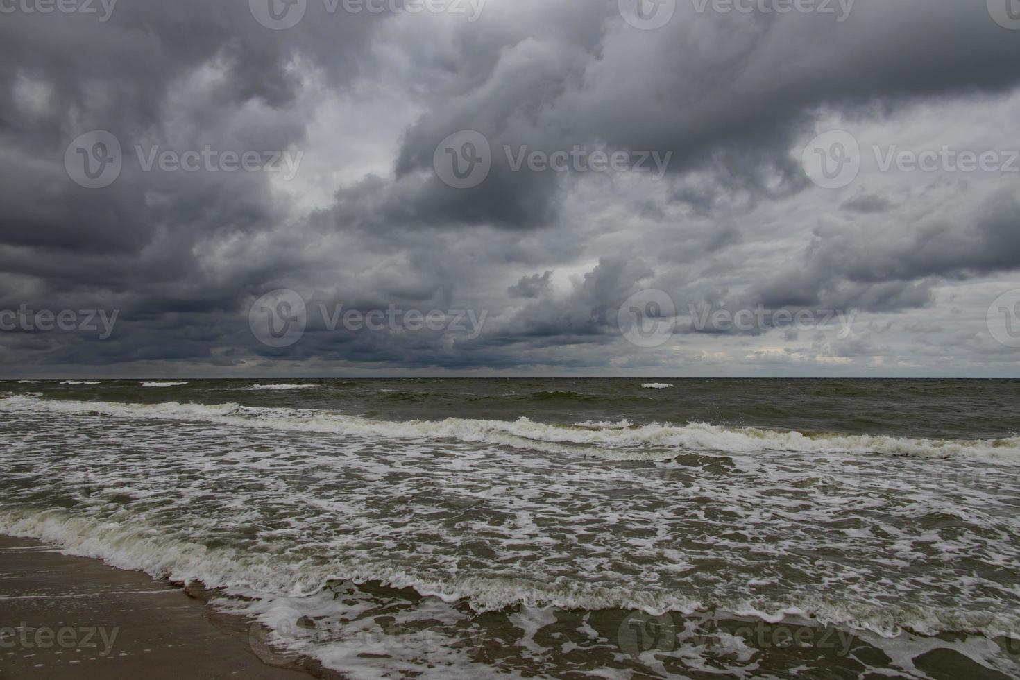 wide beach on the Baltic Sea in Poland on a summer cloudy gray cold day photo