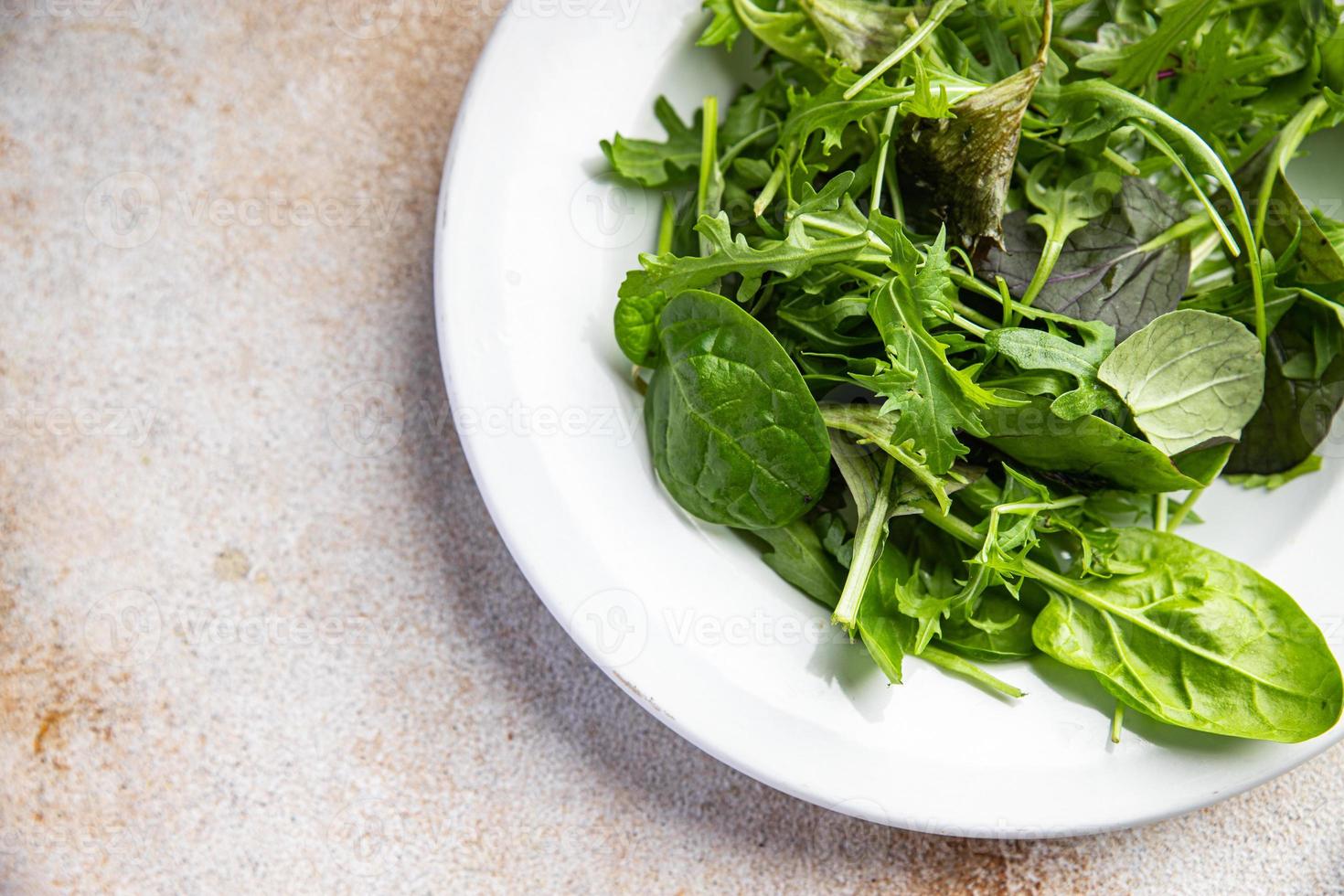 green salad leaves mix mix micro green, healthy snack food on the table copy space food background rustic top view photo