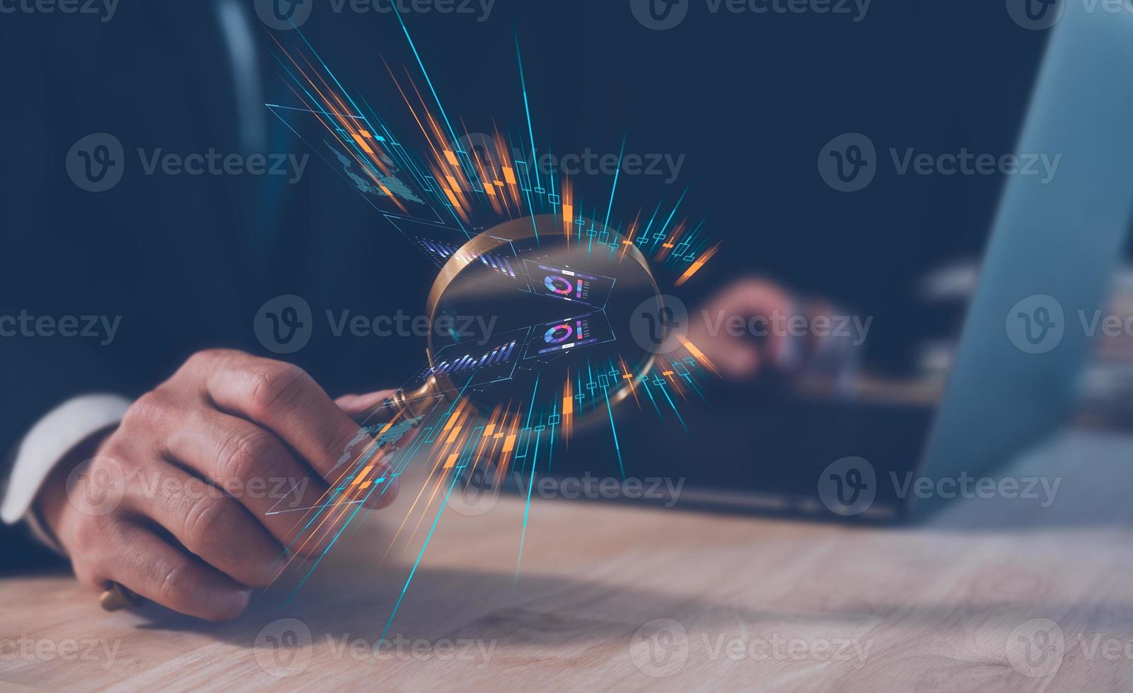 investment financial and saving concept, businessman holding magnifying glass on table with computer laptop and  virtual trading graph, business growth and investment strategy. stock market ,economy photo