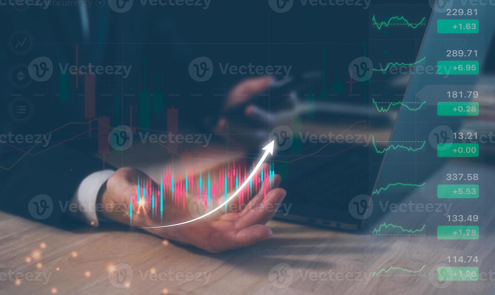 investment financial and saving concept, businessman holding virtual trading graph, working on computer laptop on table. photo