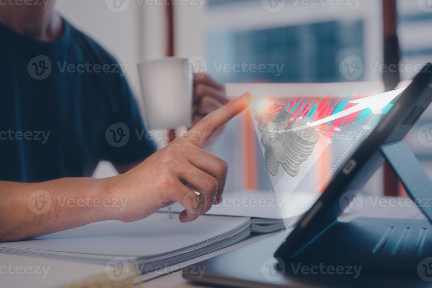 investment concept, man using tablet on table with virtual graph and blurred coins, saving fund, planning and strategy, Stock market, Business growth, progress or success concept photo