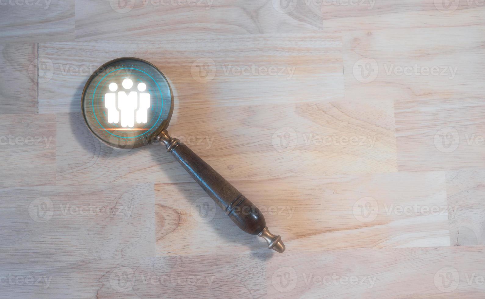 teamwork team leader HRM or Human Resource Management, magnifying glass with icon in concept of human development team recruitment leadership and customer target group concept. photo