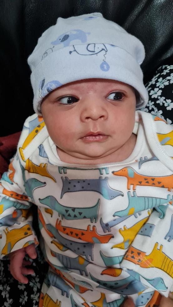 New Born Asian Pakistan Baby Boy is Relaxing. He is Named Azlan Ahmed Shah, Born on 14-March-2023 at Luton and Dunstable Hospital at Luton England UK. Image Captured on 20-March-2023 photo