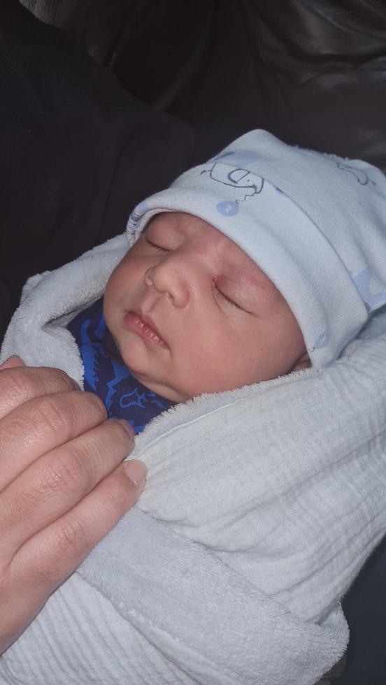 New Born Asian Pakistan Baby Boy is Relaxing. He is Named Azlan Ahmed Shah, Born on 14-March-2023 at Luton and Dunstable Hospital at Luton England UK. Image Captured on 20-March-2023 photo