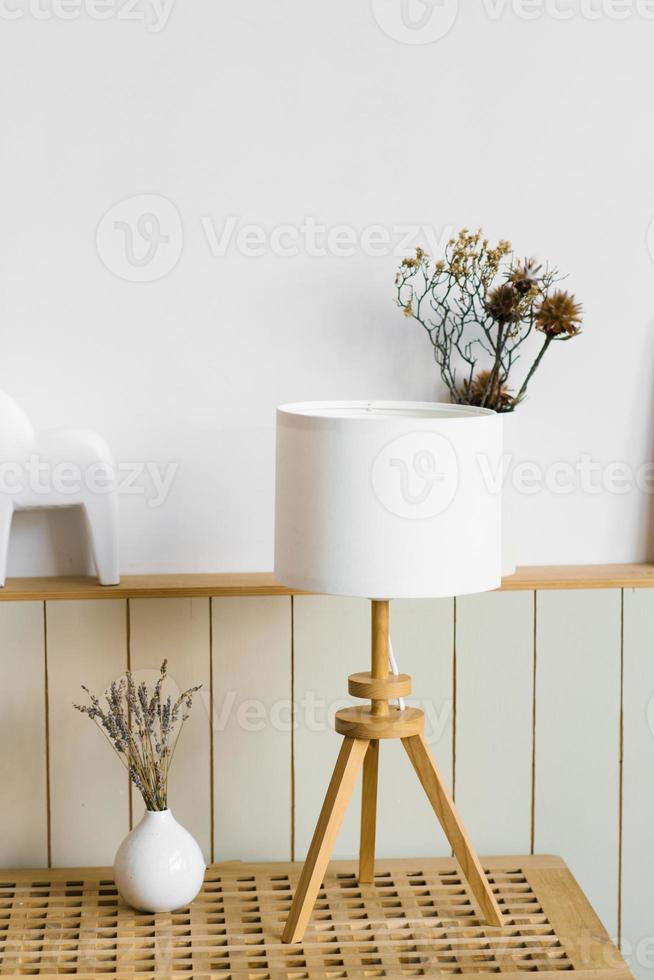 Table lamp, lavender in a white vase in the decor of the living room in a minimalist Scandinavian style photo