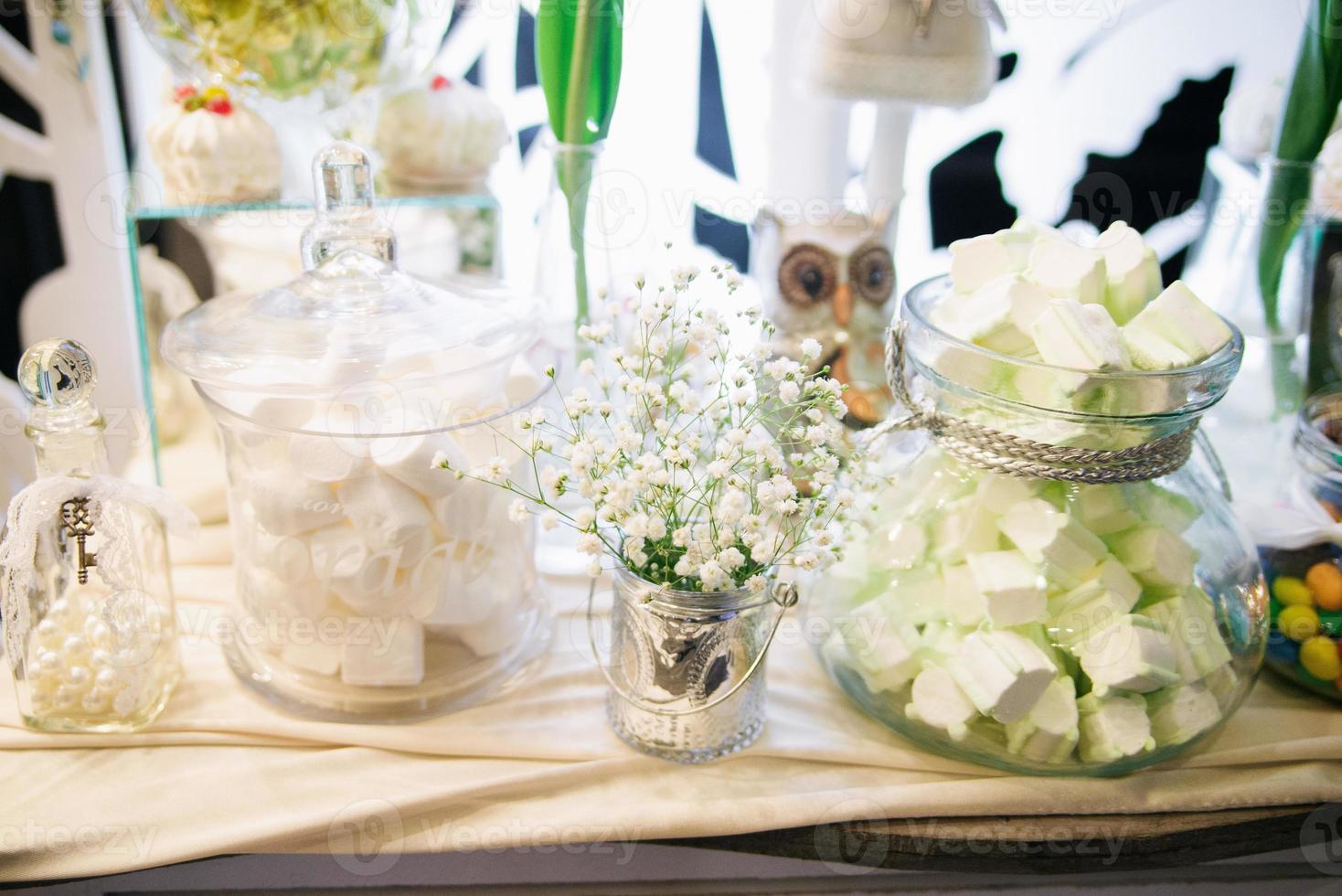 Wedding candy bar with white flowers in rustic style photo