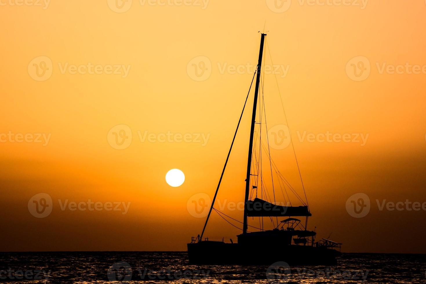 Sailing yacht at sunset photo