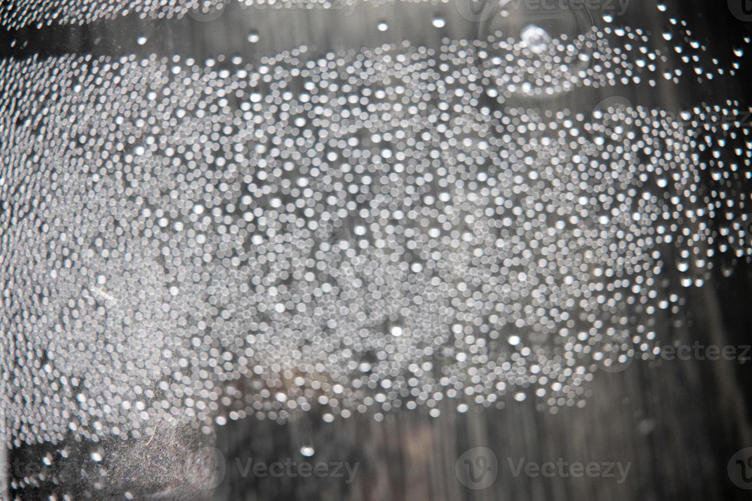 out of focus water drops in closeup creating bokeh background photo