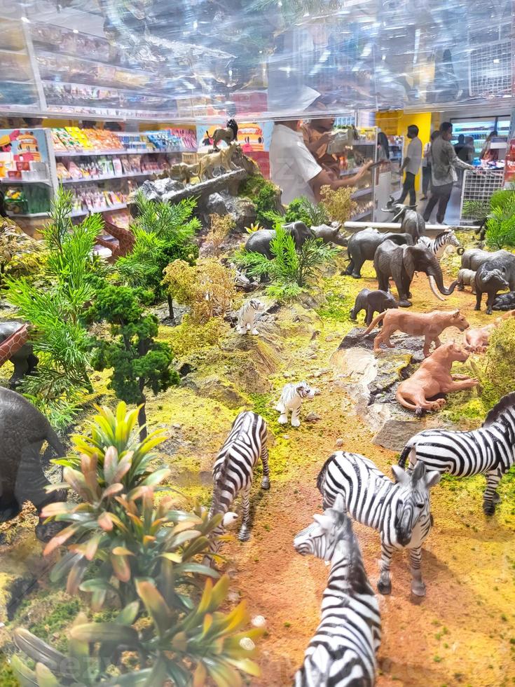 Miniature toy animals in glass cases for sale in a shop photo