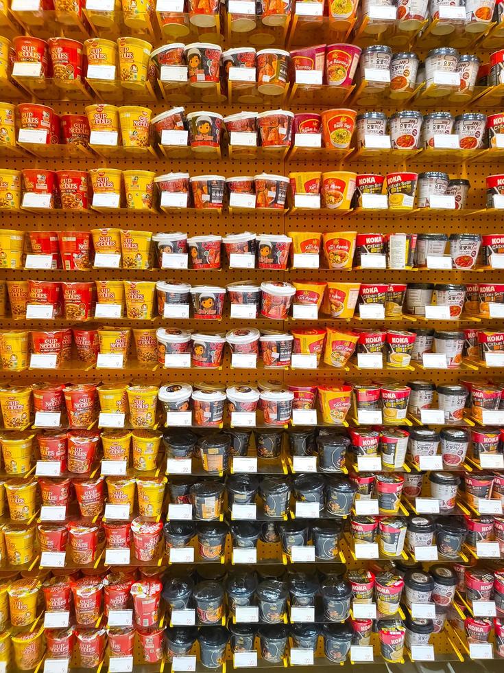 Bekasi, Indonesia - March,12 2023 Collection of instant noodles arranged on a sale rack at a convenience store in Summarecon Mall Bekasi photo