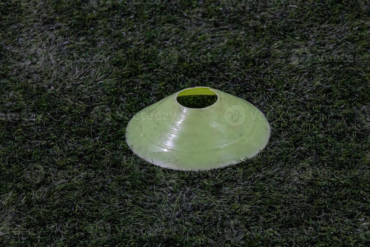 yellow marker on the artificial green field of the football field photo