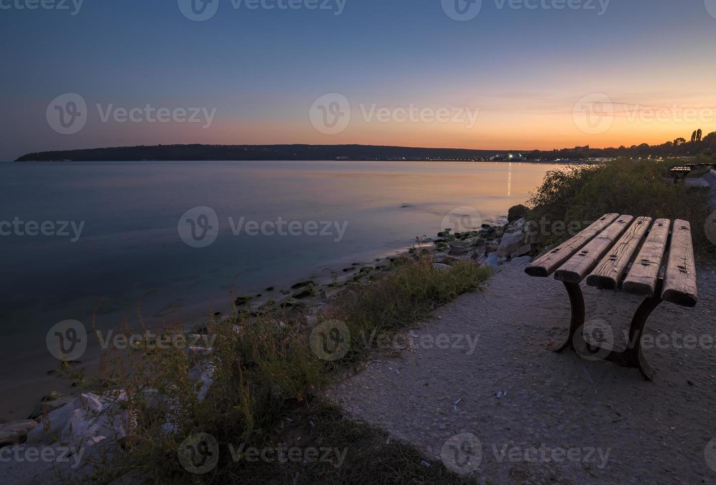 empty bench on the beach by the sea for relaxation photo