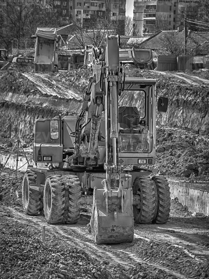 Amazing black and white view of the stopped excavator at the construction site photo