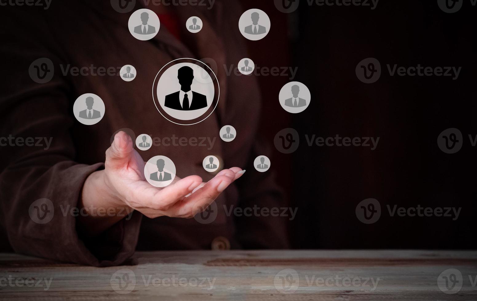 businesswoman hand with social network icon on dark background, human resources concept, Customer or employees care concept, Teamwork, network and community concept. photo