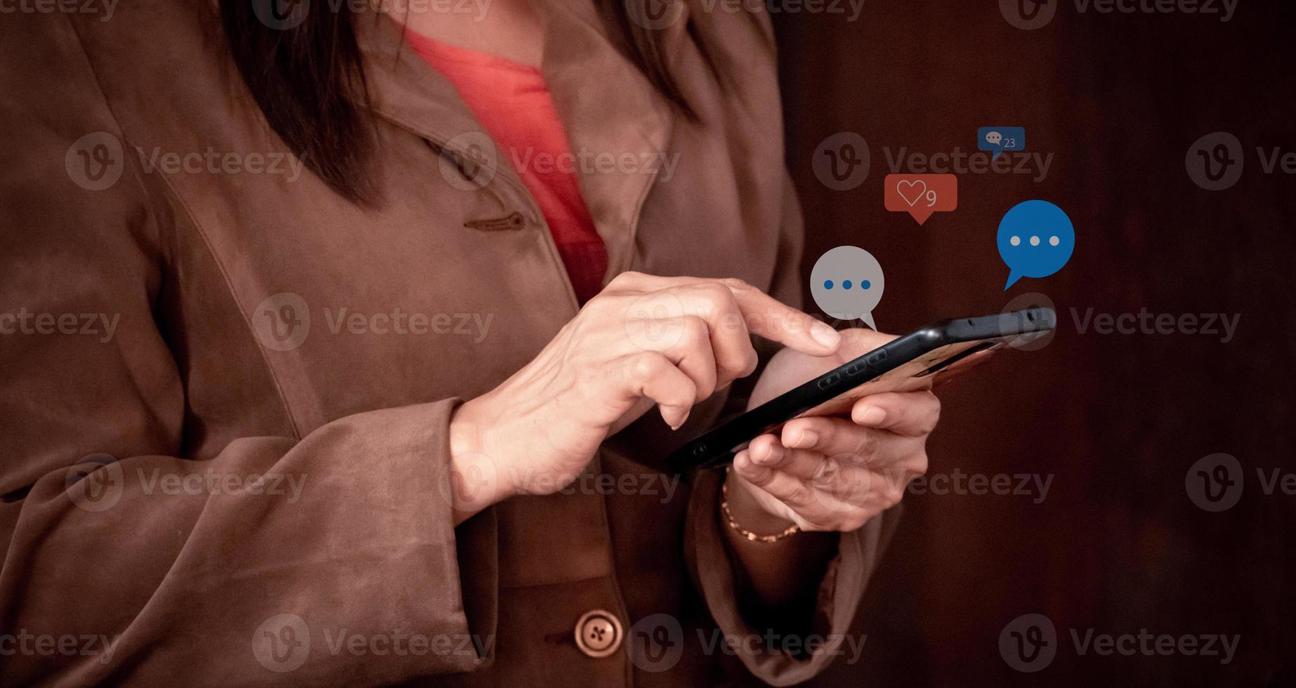 Close up of businesswoman using mobile phone with social media icons. social media and digital online concept. photo