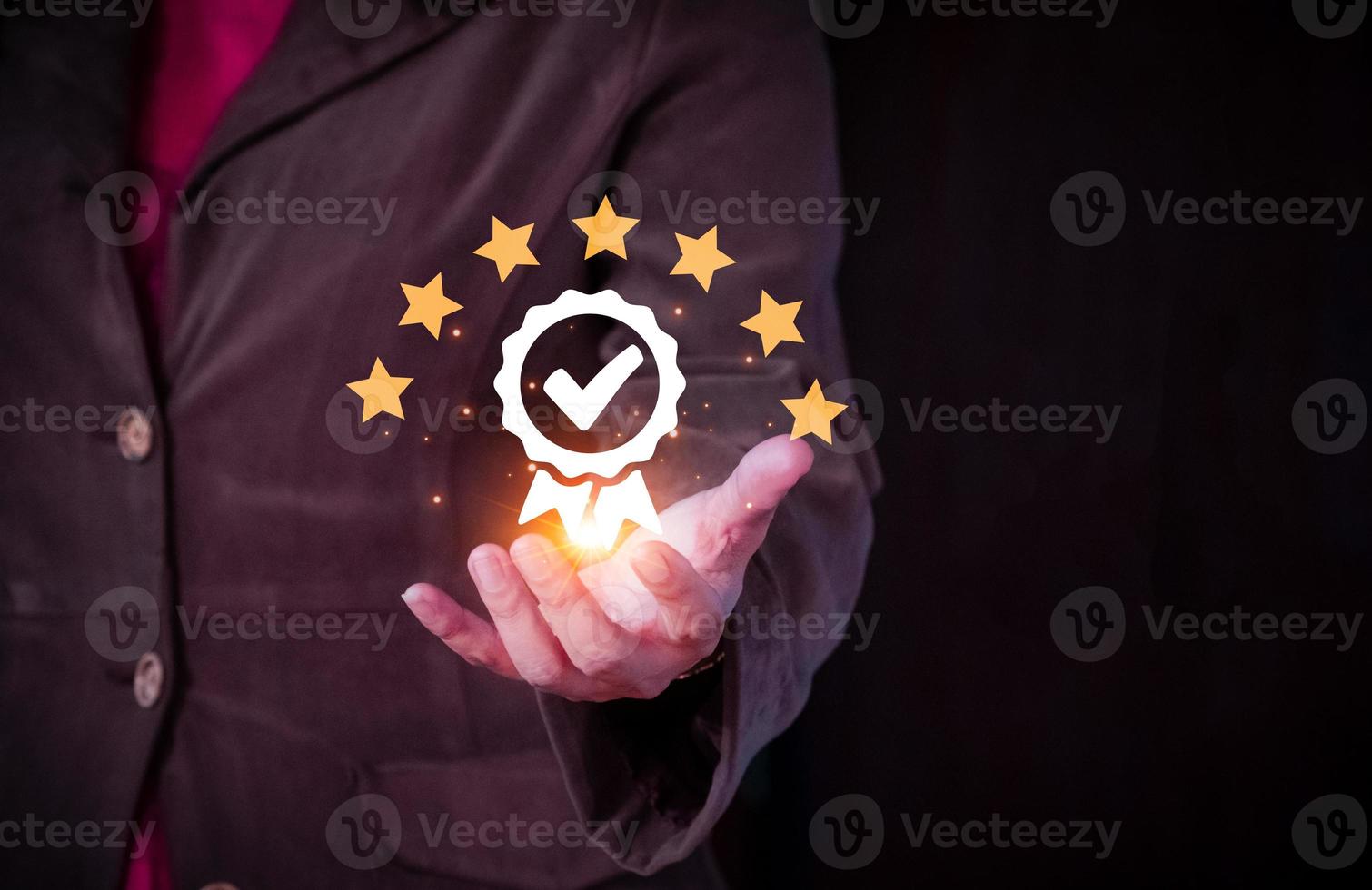Quality control concept with businesswoman holding a golden award medal on black background. Customer service evaluation concept. rating very impressed. photo