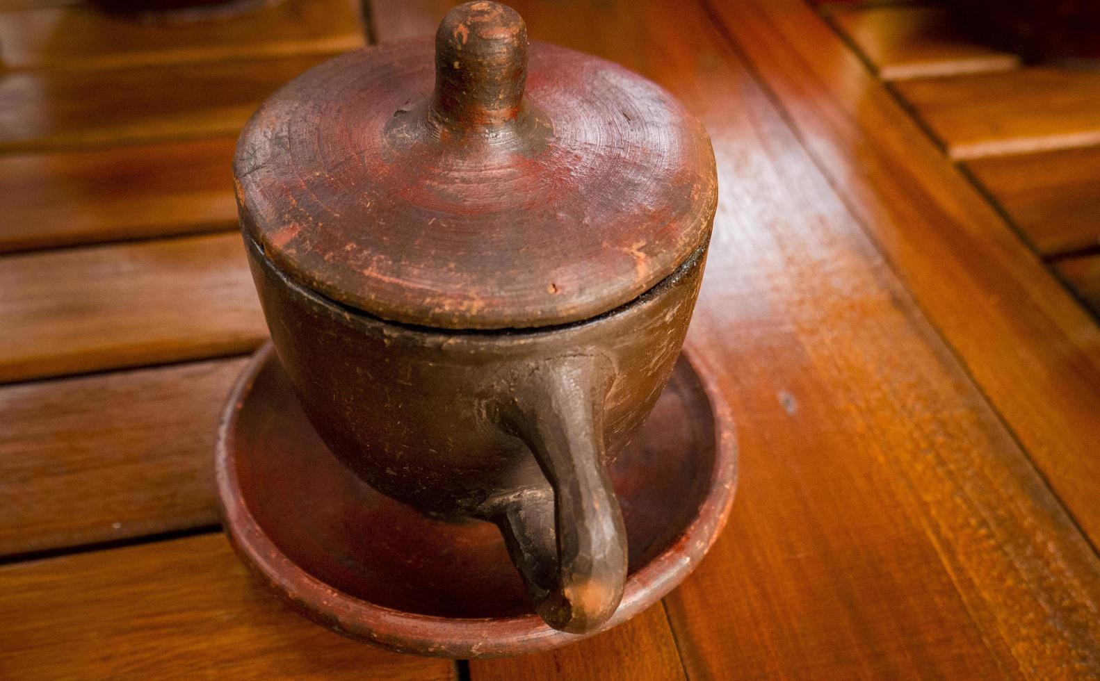 A cup Coffee with traditional cup from Jepara Central Java. The photo is suitable to use for coffee shop background and content media.