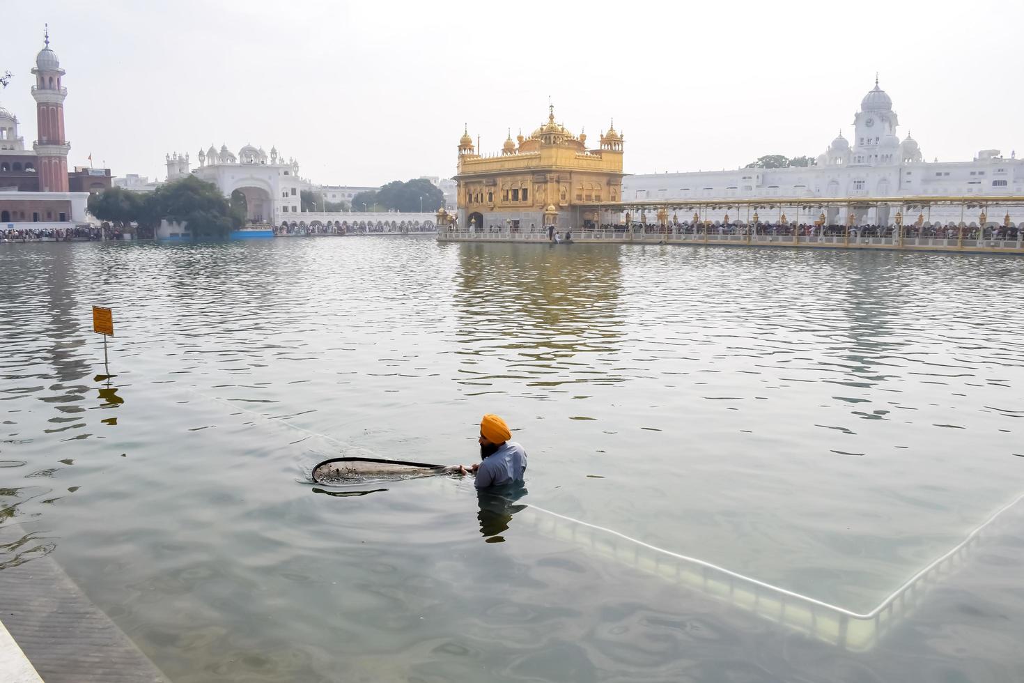 Amritsar, India - February 26 2023  - Unidentified devotees from various parts at Golden Temple - Harmandir Sahib in Amritsar, Punjab, India, Famous indian sikh landmark, Golden Temple photo
