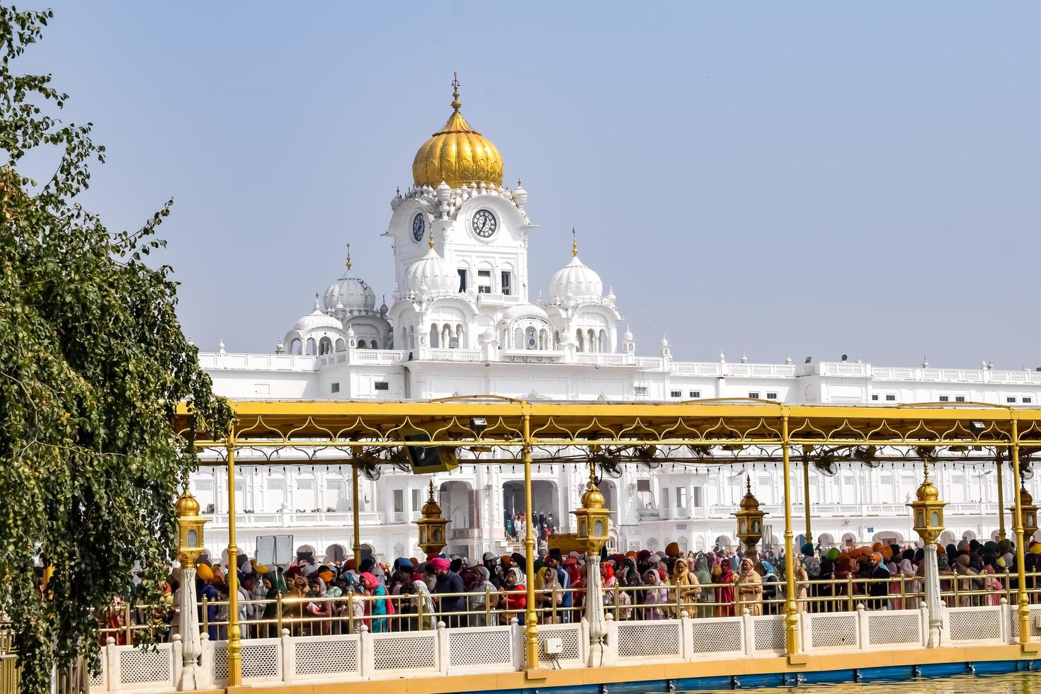 Amritsar, India - February 26 2023  - Unidentified devotees from various parts at Golden Temple - Harmandir Sahib in Amritsar, Punjab, India, Famous indian sikh landmark, Golden Temple photo
