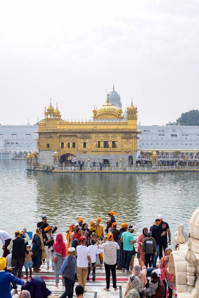 Amritsar, India - February 26 2023  - Unidentified devotees from various parts at Golden Temple - Harmandir Sahib in Amritsar, Punjab, India, Famous indian sikh landmark, Golden Temple photo