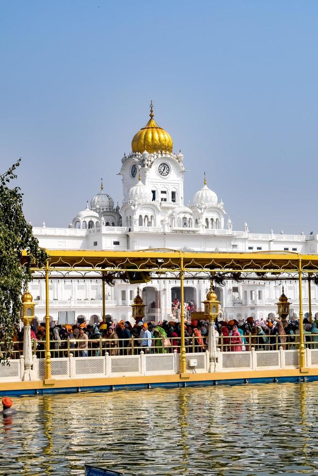 Amritsar, India - February 26 2023  - Unidentified devotees from various parts at Golden Temple - Harmandir Sahib in Amritsar, Punjab, India, Famous indian sikh landmark, Golden Temple photo