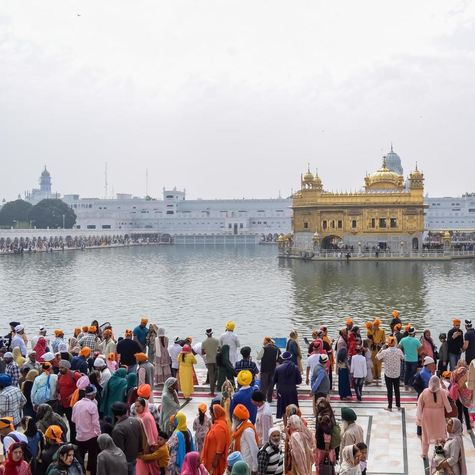 Amritsar, India - February 26 2023  - Unidentified devotees from various parts at Golden Temple - Harmandir Sahib in Amritsar, Punjab, India, Famous indian sikh landmark, Golden Temple photo