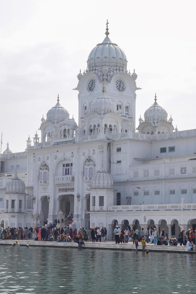 Amritsar, India - February 26 2023  - Unidentified devotees from various parts at Golden Temple - Harmandir Sahib in Amritsar, Punjab, India, Famous indian sikh landmark, Golden Temple photo