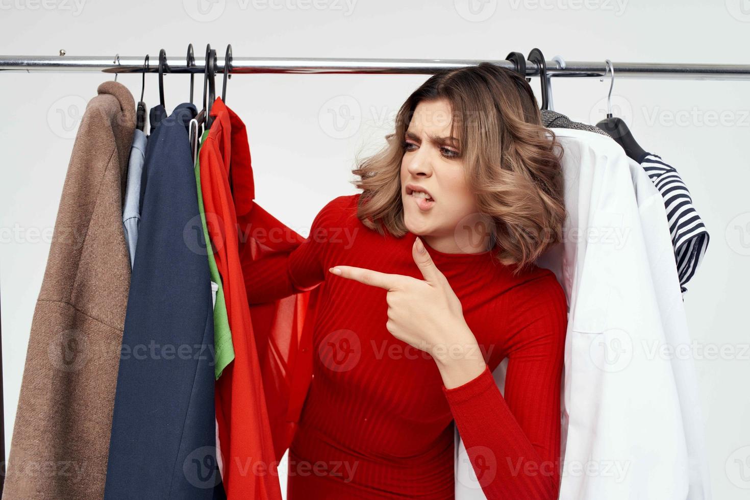 cheerful woman with glasses trying on clothes shop shopaholic isolated background photo