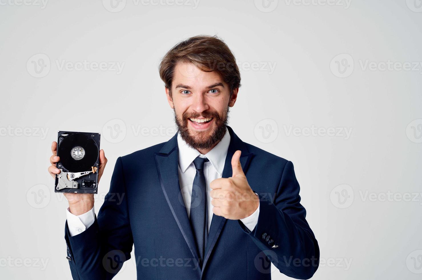 Cheerful business man with hard drive from computer data protection photo