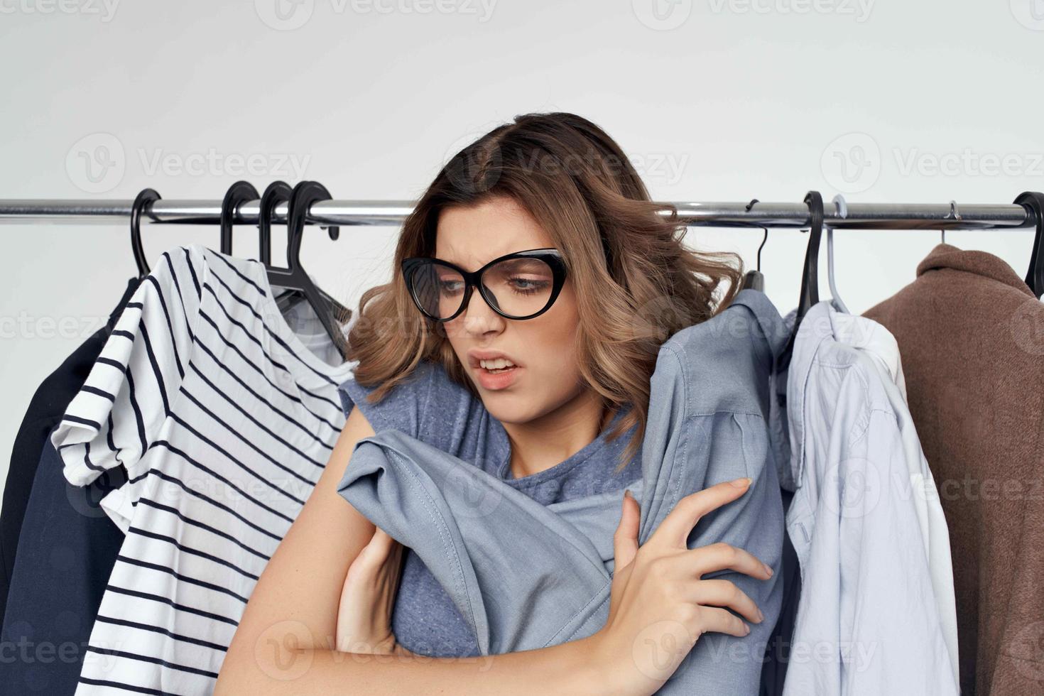 woman with glasses near clothes shopaholic isolated background photo