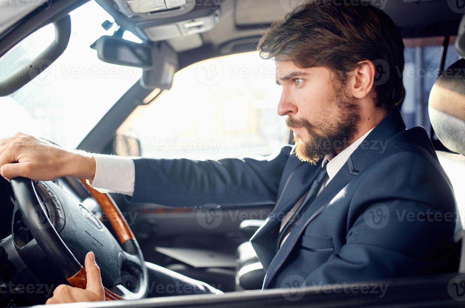 bearded man in a suit in a car a trip to work rich photo