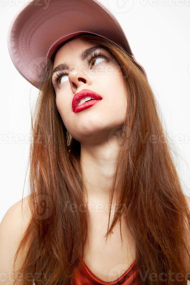 Emotional woman in a cap looking up looking sideways fashionable clothes photo